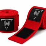 Custom red boxing hand wraps with rubber logo patch, premium cotton stretch fabric, secure hook and loop closure, breathable material, reinforced stitching, OEM private label boxing equipment manufacturer.