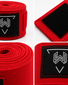 Close-up of custom boxing hand wraps showing premium rubber logo patch, reinforced stitching, hook and loop closure, and high-quality cotton fabric for professional boxing equipment.