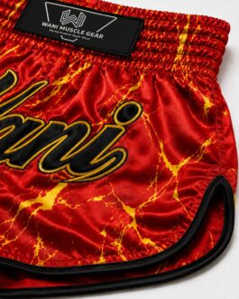 Close-up of Wani boxing shorts showing sublimation print detail, gold outline stitching, and reinforced leg hem