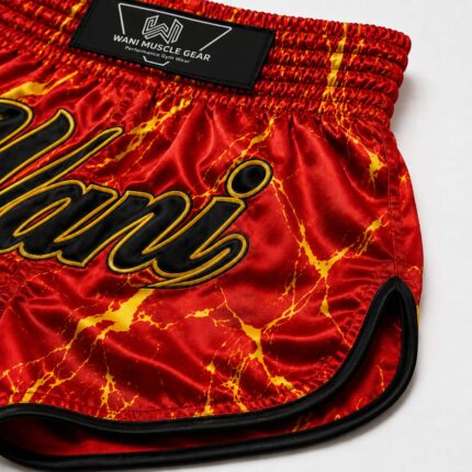 Close-up of Wani boxing shorts showing sublimation print detail, gold outline stitching, and reinforced leg hem