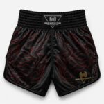 Black satin Muay Thai boxing shorts with red flame print and gold Wani logo, back view