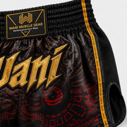 Custom Wani Muscle Gear boxing shorts waistband with gold embroidered logo and mesh side panel