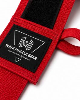 Close-up of red Wani Muscle Gear hand wrap showing woven brand label, hook-and-loop closure, and thumb loop stitching