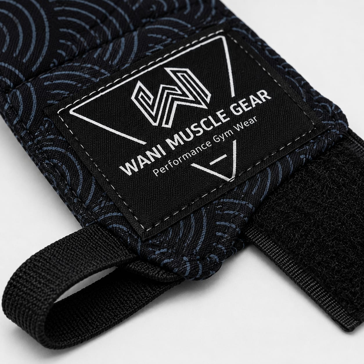 Wholesale Boxing Hand Wraps – Custom Mexican Style Hand Wraps | Wani Wear Close-up of Wani Muscle Gear custom logo patch and hook and loop closure on wholesale boxing hand wraps