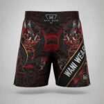 Front view of custom MMA fight shorts with matching dragon sublimation print in black, red, and gold by Wani Wear