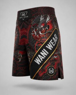 Side angled view of custom black and red dragon MMA fight shorts with Wani Wear branded waistband and side slit