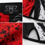 Close-up details of Wani Wear fight shorts showing branded waistband patch, side slit stitching, and sublimated fabric texture