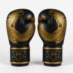 Black and gold custom boxing gloves with dragon print — Wani Wear wholesale competition gloves