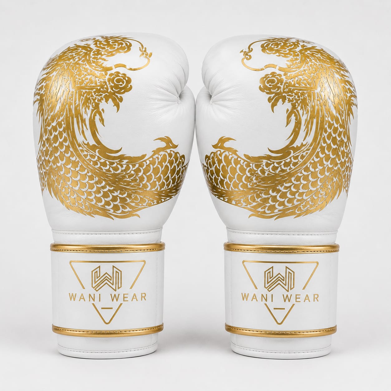 Wani Wear – Dragon Series Boxing Gloves (White & Gold Edition) White and gold Wani Wear boxing gloves front view with dragon logo branding