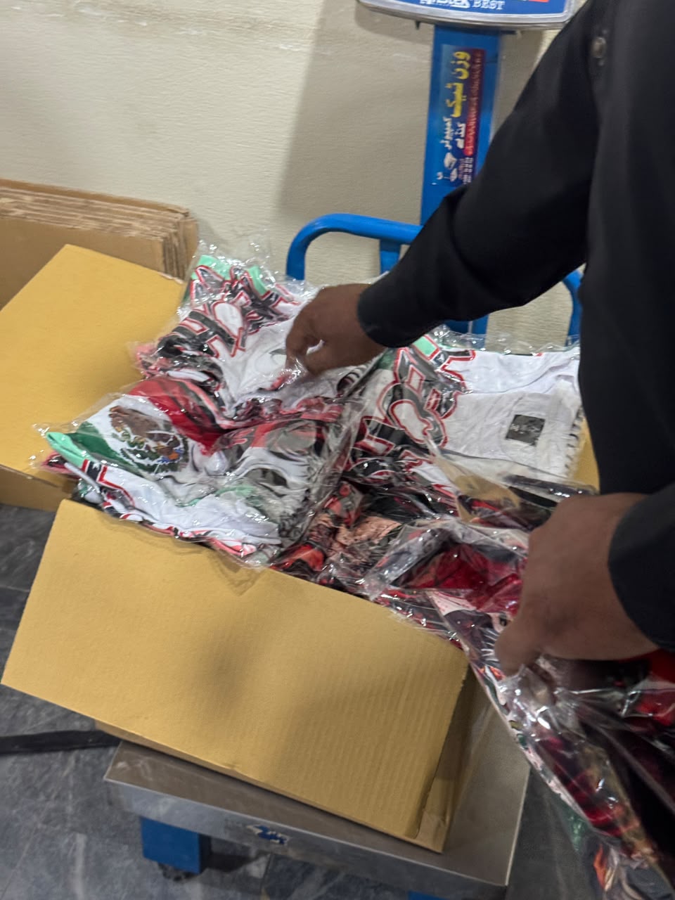 Free Worldwide Shipping Custom Orders Wani Wear team packing and weighing a custom fight wear parcel for free worldwide shipping